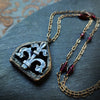 fleur de lis - garnet arch window amulet - antiqued sterling & bronze